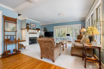 A large family room with wood burning fireplace is open to the kitchen/nook area and is a wonderful gathering space for entertaining or enjoying a quiet evening at home.