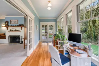 Just off the family room is this enclosed sun porch with French doors and sliding doors. Views to the beautiful yard are also enjoyed from here.