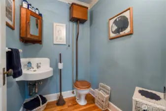 Vintage bathroom with unique toilet and old-school sink.