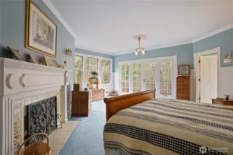 The primary bedroom is located on the second floor and enjoys a private deck with territorial views, wainscoting,  wood burning fireplace, and a 5-piece bathroom.