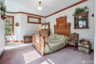 Another guest bedroom enjoys a portion of the turret that decorates this Victorian-style home