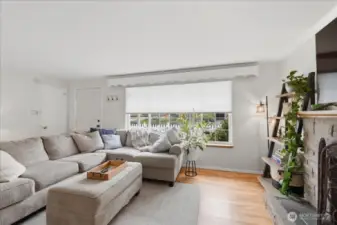 Large picture window overlooks the delightful front yard and pours natural light into the room.