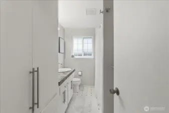 Beautifully remodeled full bath has custom tile and handsome fixtures.