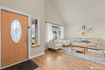 Step into a light-filled living space, where a welcoming foyer and soaring vaulted ceilings create an open, airy first impression.