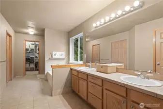 Primary en-suite with large soaking tub, double vanity and 2 walk in closets.