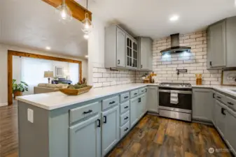 Kitchen with custom tile work, beautiful painted cabinets and quartz countertops