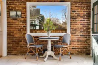 Set up a breakfast table, a spot for afternoon coffee breaks, a place for family and friends to sit and keep you company while you cook. The door to the right opens to the back steps which lead directly to the patio for outdoor dining.