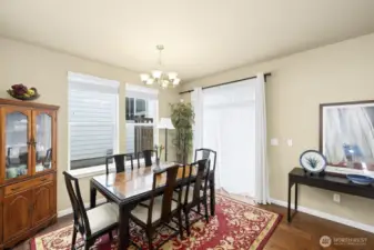 Elegant dining room next to a roomy space toward the kitchen.