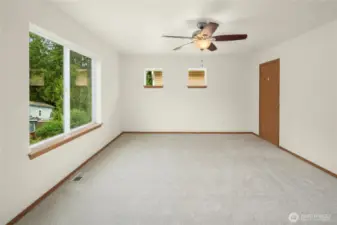 -Primary suite is a spacious room with lots of natural light from the 3 windows.   Ceiling fan with light added on to control the ideal temperature.  Yes, there is AC but sometimes a fan helps the air flow.