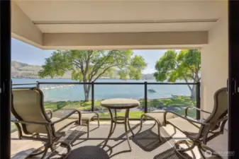 The covered deck on this corner unit is a perfect spot to relax, entertain and admire the stunning view & water activities.