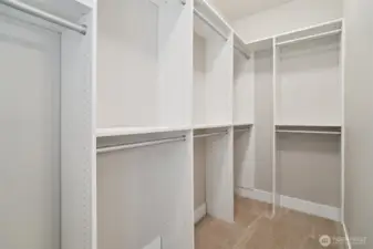 Primary walk-in closet features upgraded closet system