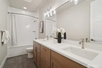Hall bath with bathrub and dual undermount sinks