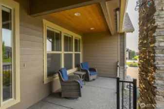A cozy front porch. Note the wood ceiling, and the shade for the bright moments of the day.
