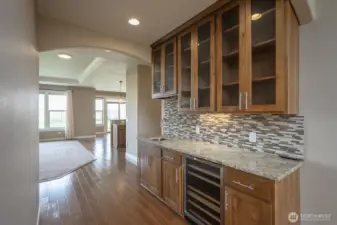 Looking from the Formal Dining Room towards the Kitchen. Note the Wine Cooler, Wet Bar, and all the shelving and cabinetry!