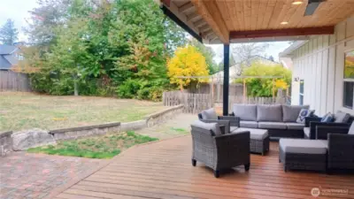 Fenced backyard with a separate fenced garden bed area to the north side near the shed.