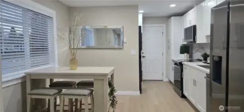 Main Home: Light-Filled Eating Area and Modern White Kitchen