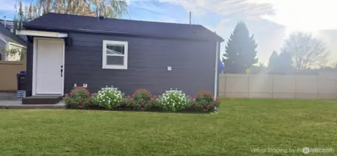 DADU Entrance: Virtually staged with vibrant green grass and flowers to showcase the front yard’s potential! Consider adding an awning to extend the living space and enjoy it year-round.