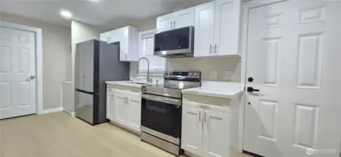 DADU: White Cabinets with Stainless Steel Appliances