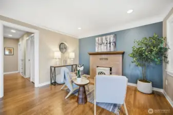 Sitting area in front of wood burning stove features original fireplace surround tiles.