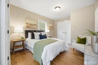 Main floor bedroom is off of family room and also accessed from hall.  Closed door opens to step in closet.