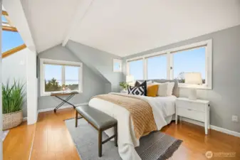 Upper primary bedroom features engineered hardwood floors, a walk-in closet, it's own atrium and vast views from the many windows.