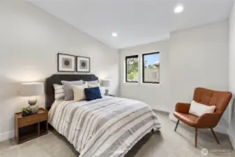 This bedroom offers a clean, contemporary feel with soft neutrals, layered textures, and warm accents.