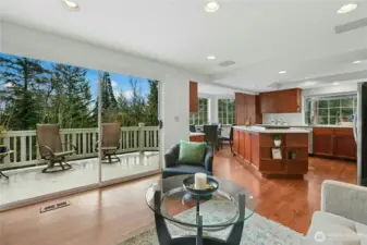 The kitchen and family room open to the main floor deck. Dining alfresco is a breeze. And when the sun is too much, you have electric blinds ready to drop across the sliding door. How easy is that?