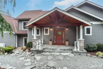 The front entrance proudly portrays the timeless aesthetics and values of a Craftsman home, one that never go out of style