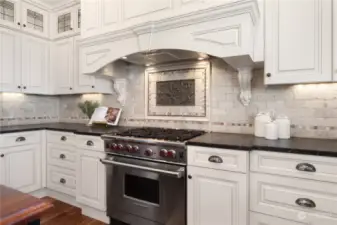 Gorgeous kitchen with a fantastic Wolf 6-burner propane range and oven. There's a second oven on the wall to the left.