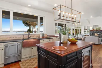 Note the hammered copper apron sink and dual dishwasher on the main counter, and the copper wet bar and built-in wine cooler on the island.