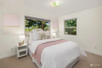 Bedroom #1 is spacious and large enough to fit a Queen or King bed, with windows that look out to natural foliage