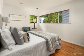 Large main floor bedroom with gorgeous garden views.