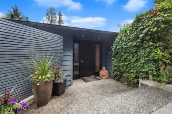 Classic Mid-Century modern entrance with lush vegetation and a Zen vibe.