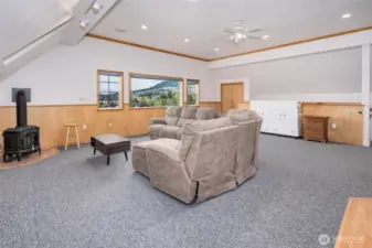Furnished studio space with white Murphy bed and gas stove.