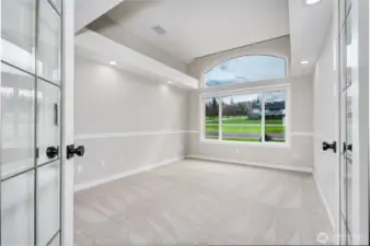 French doors open to office off of foyer, with interesting ceiling detail.