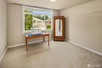 The 3rd bedroom upstairs facing the front yard / driveway