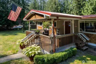 This wonderful front covered deck is a great space for being outside year round