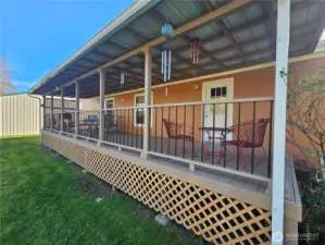 Covered deck along the back of the home overlooking the river.
