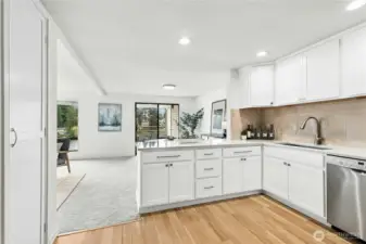 L shaped counter bar opens to dining and balcony view