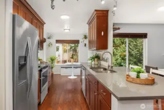 Large Kitchen Features Stainless Steel Appliances, Quartz Counters, Breakfast Nook Surrounded by Windows