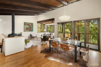 Stairs on the left lead to primary suite, two additional bedrooms, full bath, and laundry.  All three bedrooms enjoy sliders to the lower deck, which spans the entire length of the home.