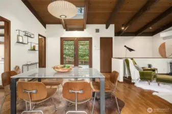 A cute powder room is tucked behind the door that's ajar on the left. The doorway on our immediate left leads to the kitchen.