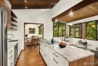 Mirroring the bump-out in the living room, this space in the kitchen offers additional seating, and perhaps a fun bar cart as we're showing here.  The window looks across the deck into the living room, for a lovely sense of connectivity to that space.