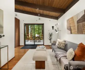 A slider connects the kitchen and flex space to the large side deck.