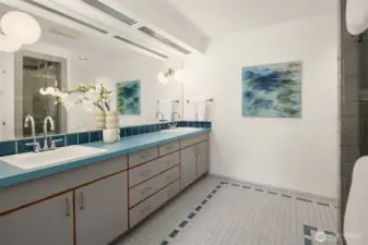 The primary bath is gracious in scale, with an expansive double vanity and large walk-in shower with built-in seating.