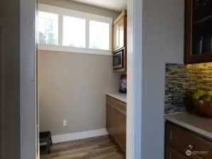 Butler's pantry off kitchen with freezer, cabinets, sink with insta hot.