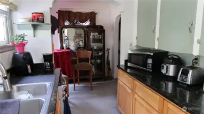 Kitchen opens up to a walk-around to dinette area and into the front room and fireplace.