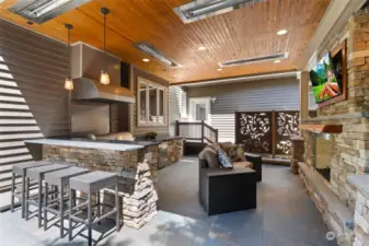Endless outdoor enjoyment awaits with this barbeque, fridge, gas fireplace, TV, bar, and beautifully hardscaped patio! Chilly evening?? Turn on the built-in overhead heaters!!