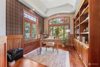 Tucked away just off of the entry is this impressive executive office space full of wood accents and custom bookcases.