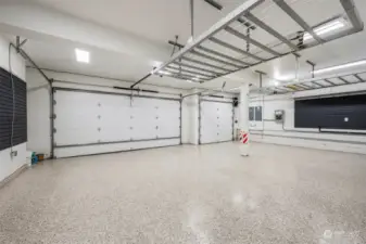 Ready to be amazed by a garage? This fabulous space was recently updated with brilliant epoxy floors, new garage doors and openers, overhead storage racks, and slat walls! Home includes a Generac generator system!